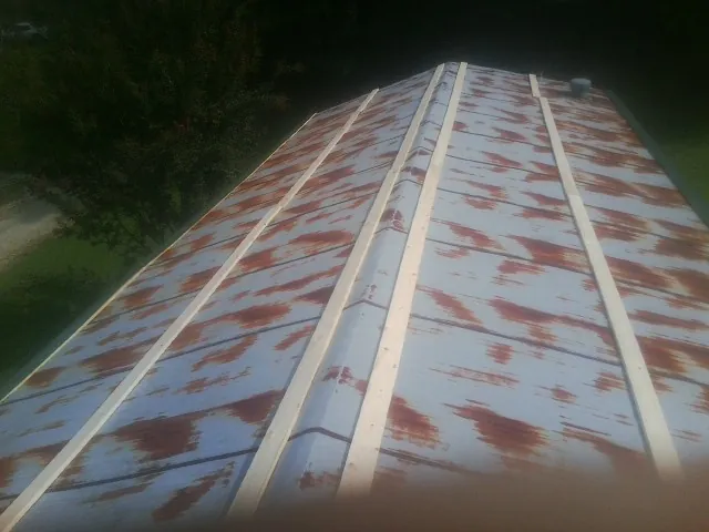 Rusted metal roof panels with new wood purlins before replacement — Storm Damage Roof Repair in San Felipe by Roofing Brothers