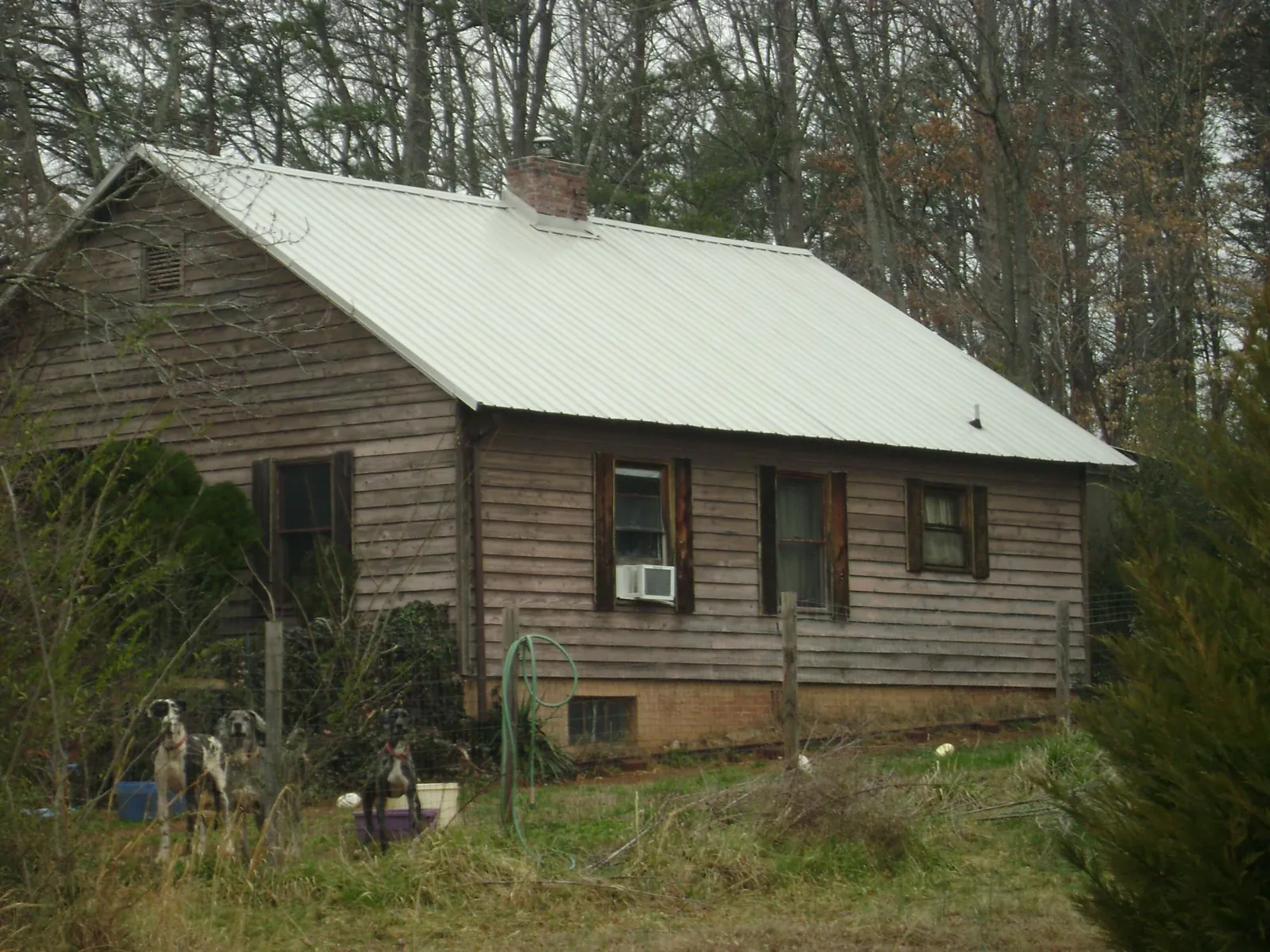 White metal roof on an old wood sided farmhouse, from a Metal Roof Installation job in San Felipe