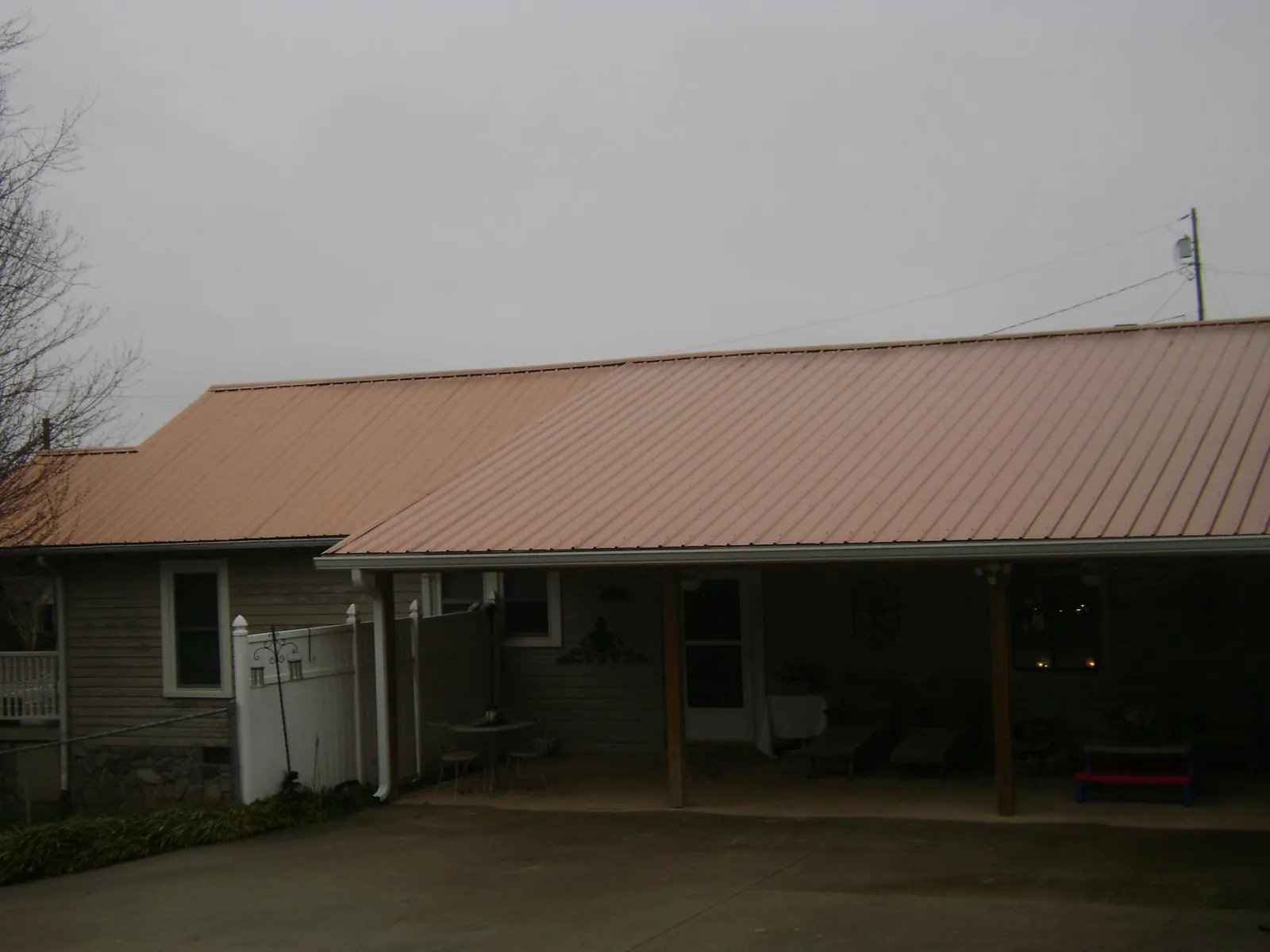 Copper toned metal roof over a wide covered patio in San Felipe